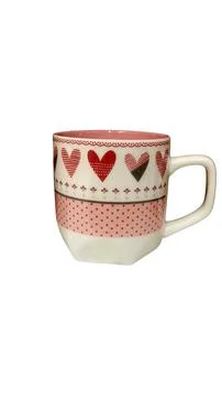 Close-up of a charming ceramic coffee mug with heart and polka dot patterns. Stock Photos
