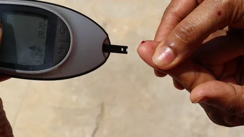 Close up of checking blood sugar level at home, checking blood sugar level Stock Footage 247428421