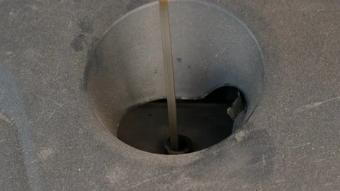 Close-up of checking the oil level on the yellow knob oil dipstick in a used car Stock Footage 166996085