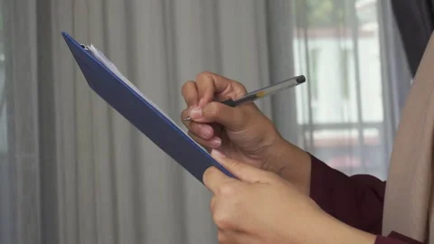 Close up of checking or taking notes on a clipboard while standing Stock Footage 277316369