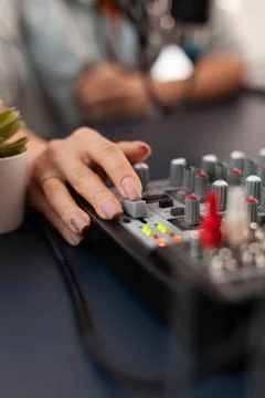 Close up of checking sound using mixer during online podcast Foto stock