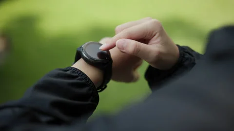 Close-up checking sportswear adjusting smart watch before workout in park. Stock-Footage 231664334