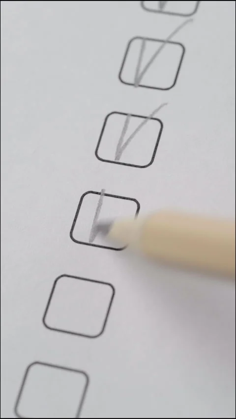 Close-Up of Checklist Boxes Being Ticked with Pencil, Pencil Dropped Beside Video stock 329849623