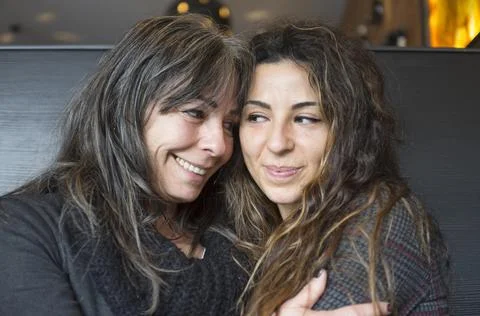 Close up of cheerful affectionate two aged mum and daughter enjoy hug Stock Photos