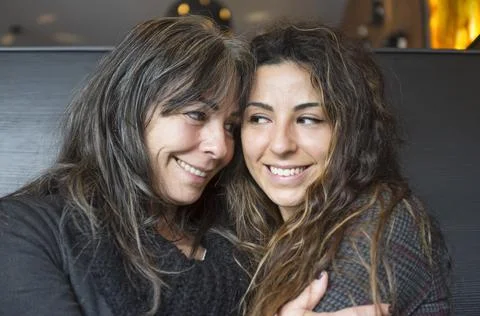 Close up of cheerful affectionate two aged mum and daughter enjoy hug Stock Photos