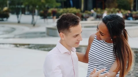 Close-up of cheerful multiracial couple having date in a beautiful park Stock Footage 119957056