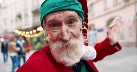 Close up of cheerful Santa talking on video call while standing on street in Stock Footage 142241027