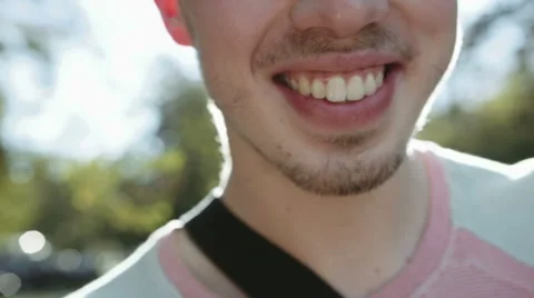 Close up of cheerful young man face smiling widely. Stockbeeldmateriaal 43220864