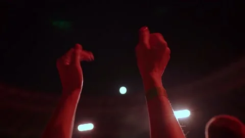 Close-up of cheering hands at a concert in front of a large stage. Stock Footage 225288142