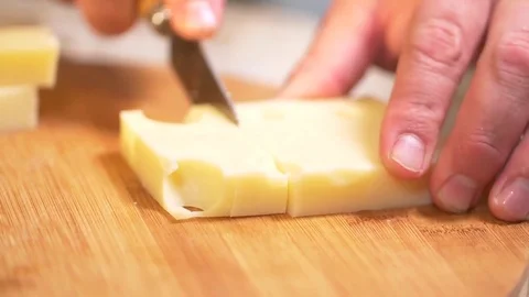 Close Up On Cheese Being Sliced Into Strips On Cutting Board In Slow Motion Stock Footage 83360321