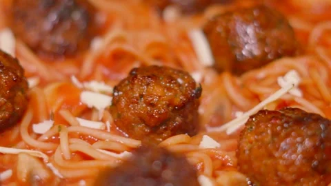 Close Up of Cheese Falling onto Italian Meatballs with Spaghetti Pasta in Rich Stock Footage 301059191