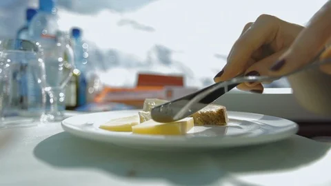 Close up of a cheese plate while traveling by train in winter alps Stock Footage 122533982