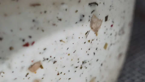 Close-up of a cheese wheel in storage. Round of cheese. Smooth movement of the 库存影片 175440290