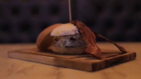 Close Up of Cheeseburger made with Two Burgers, Bacon and Egg Stock Footage 129044561