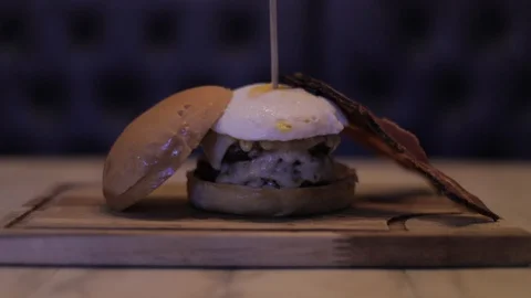 Close Up of Cheeseburger made with Two Burgers, Bacon and Egg Stock Footage 129044562