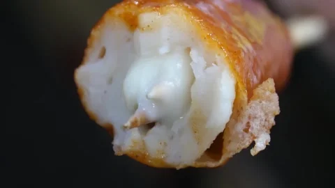 Close-up of Cheesy Korean Fish Cake Bar (Eomuk-bar) on Skewer Stock Footage 337374317