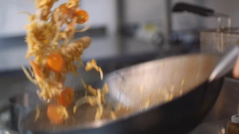 Close-up chef actively working in the kitchen of an Asian restaurant Stock Footage
