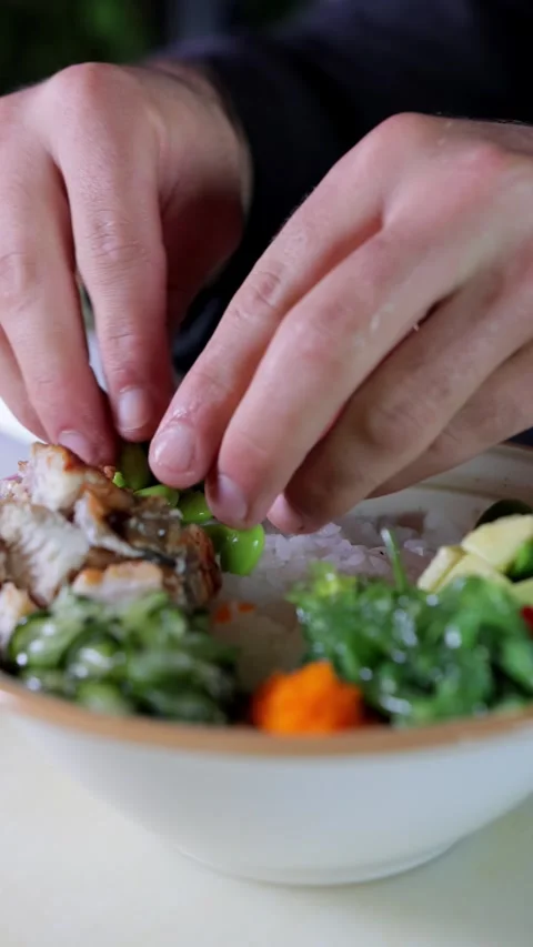 Close-up of Chef Adding Beans to Poke Bowl, Vertical Video Stock Footage 288577349