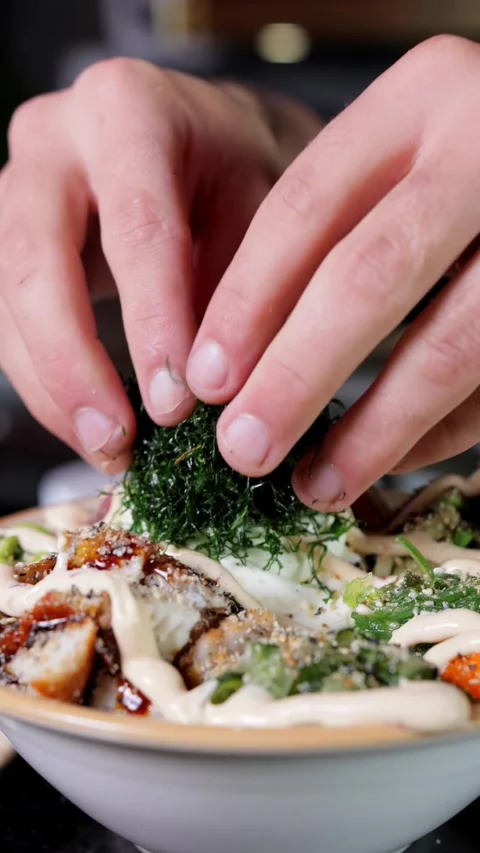 Close-up of Chef Adding Chopped Nori to Poke Dish, Vertical Video Stock Footage 288577527