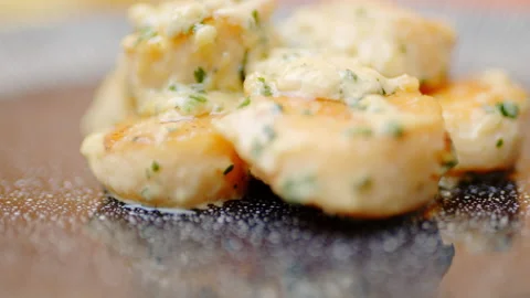 Close-up of a chef adding cream sauce on top of the scallops in a serving plate. Stock Footage 138068146