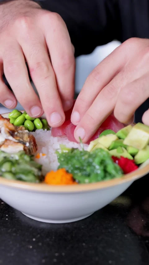 Close-up of Chef Adding Tuna to Poke Bowl, Vertical Video Stock Footage 288577440