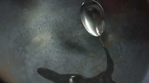 Close-up of chef adds in a cast-iron frying pan olive oil to cook dishes Stock Footage 158810994