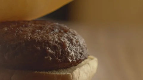 Close-up of chef adds slice of cheese to cutlet. Cooking burger. Slow motion Stock Footage 116036005