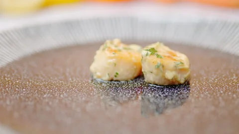 Close-up of a chef arranging creamy scallops in a serving plate in 4K. Stock Footage 138067980