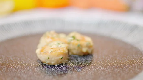 Close-up of a chef arranging creamy scallops in a serving plate in 4K. Stock Footage 138067988