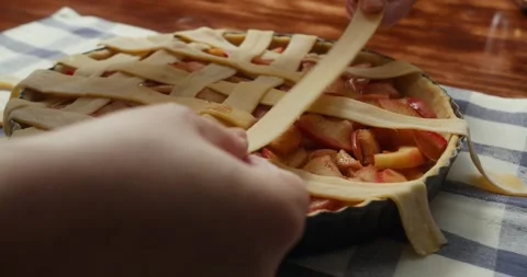 Close-up of a chef assembling an apple pie ready for the oven, homemade dessert Stock Footage 325886989