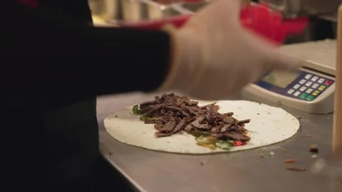 Close up of Chef Assembling many Shawarma Wraps with Grilled Meat, sauce and Vídeo Stock 341780657