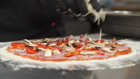 Close-up of chef baker in black latex gloves making pizza at professional Stock Footage 121408918