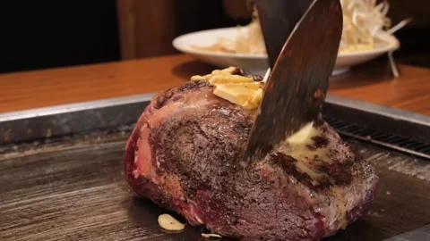 Close-up of Chef Basting Marbled Wagyu Beef Steak with Butter and Garlic on Tepp Stock Footage 333600181