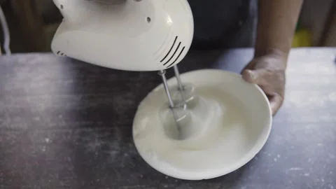 Close up chef beating eggs with an electric mixer Stock Footage 272495934