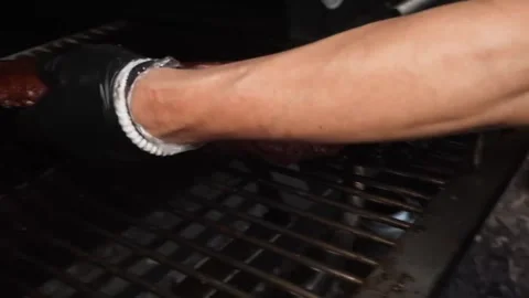 Close-up of Chef in Black Gloves Grilling Juicy Barbecue Pork Ribs on Outdoor Me Stock Footage 338213677