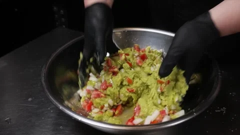 Close-up of a Chef in Black Gloves Mixing Freshly Chopped Vegetables in a Metal Stock Footage 331636298