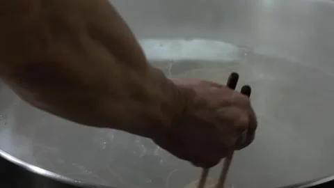 Close-up of Chef Boiling Glass Noodles in Large Metal Pot Stock Footage 333523837