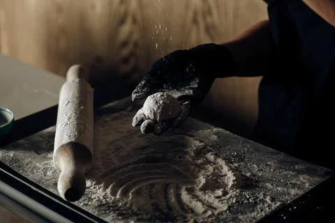 Close-up of a chef carefully dusting a dessert with flour, one hand holding.. Stock Photos