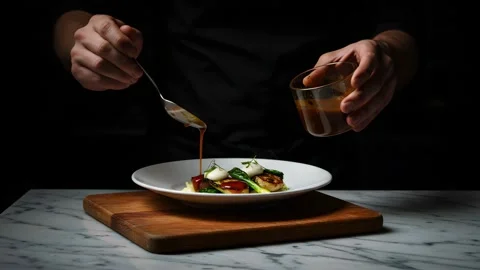 Close-up of a chef carefully plating a fine dining dish Video stock 318859435