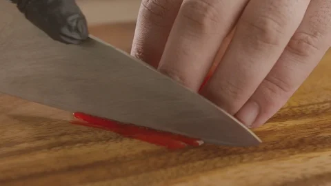 Close-up of chef chopping bell pepper with sharp knife. Slow motion video Stock Footage 114863067