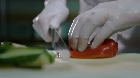 Close-up of chef chopping a carrot with red pepper on cutting board Stock Footage 68562059