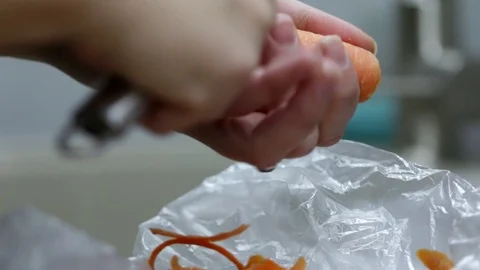 Close-up of chef chopping a carrot with red pepper on cutting board. Stock Footage 70759546