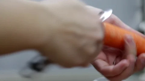 Close-up of chef chopping a carrot with red pepper on cutting board. Stock Footage 70759844