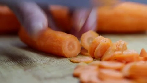 Close-up of chef chopping a carrot with red pepper on cutting board. Stock Footage 70760137