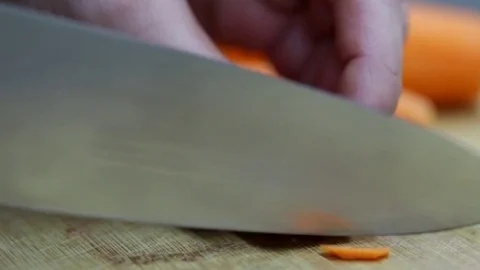 Close-up of chef chopping a carrot with red pepper on cutting board. Stock Footage 70760158