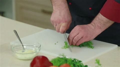 Close-up of a chef chopping dill. Frontal shot Stock Footage 50760000
