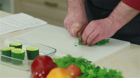 Close-up of a chef chopping parsley. Frontal shot Stock Footage 50759828