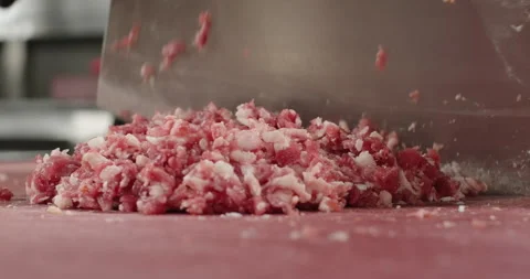 Close-up chef chops meat with a big knife axe on the cut board in the restaurant Stock Footage 264815021