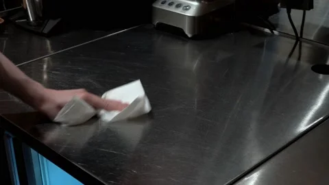 Close up of chef cleaning hid workplace spraying sanitizer over kitchen table Stock Footage 165554674