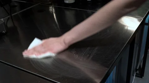 Close up of chef cleaning hid workplace spraying sanitizer over kitchen table Stock Footage 165554738